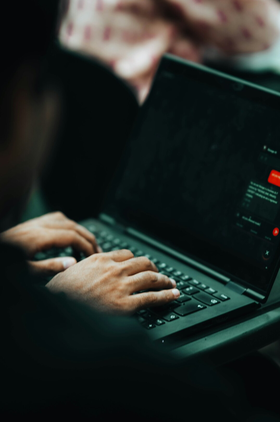 writer typing on laptop at night