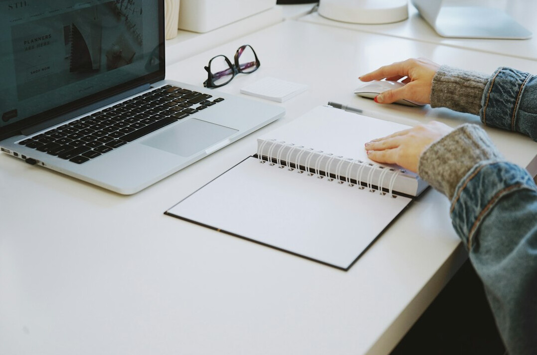 tense writer at desk with notebook